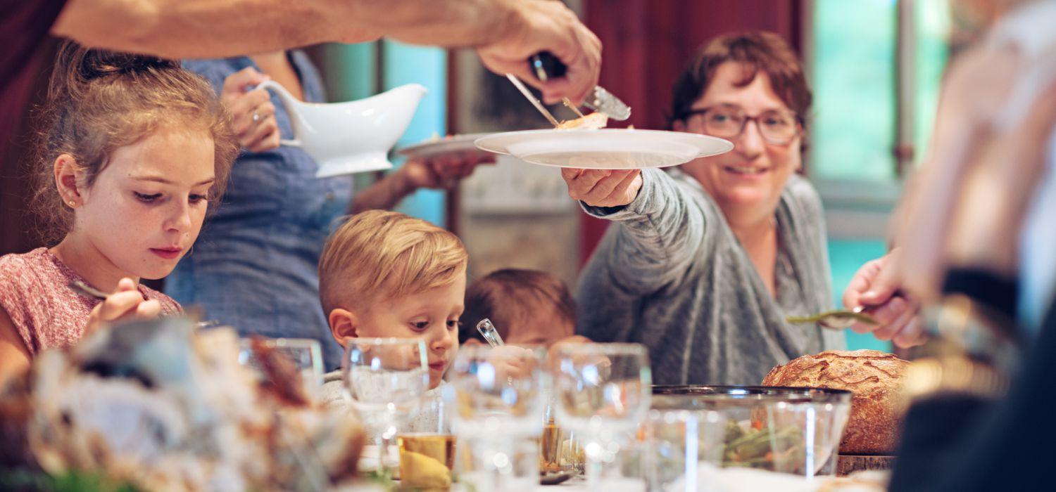 family passing food on the table