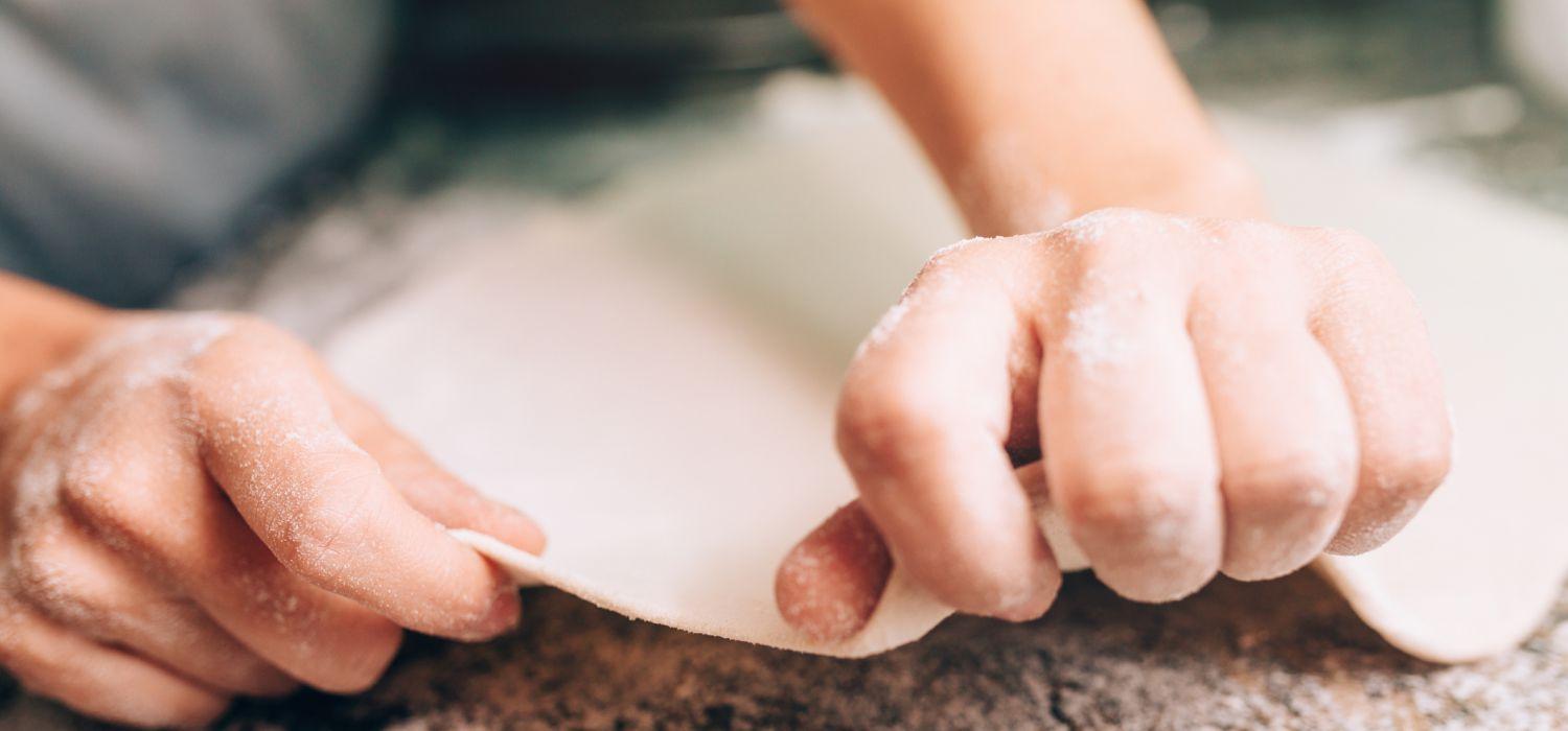 hands of person making dough